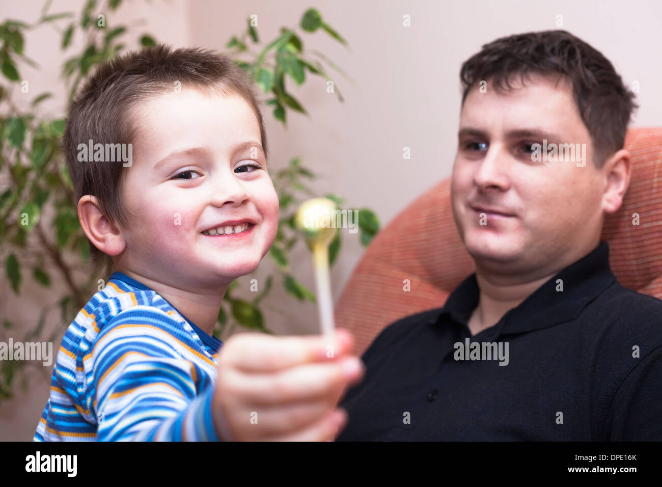 Man and happy child boy with lollipop Stock Photo