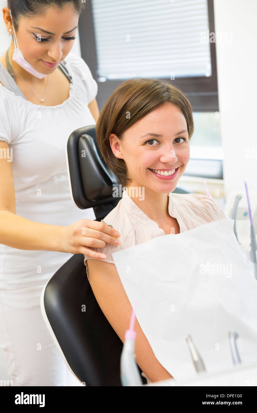Young woman in dentists chair with dental nurse Stock Photo Alamy