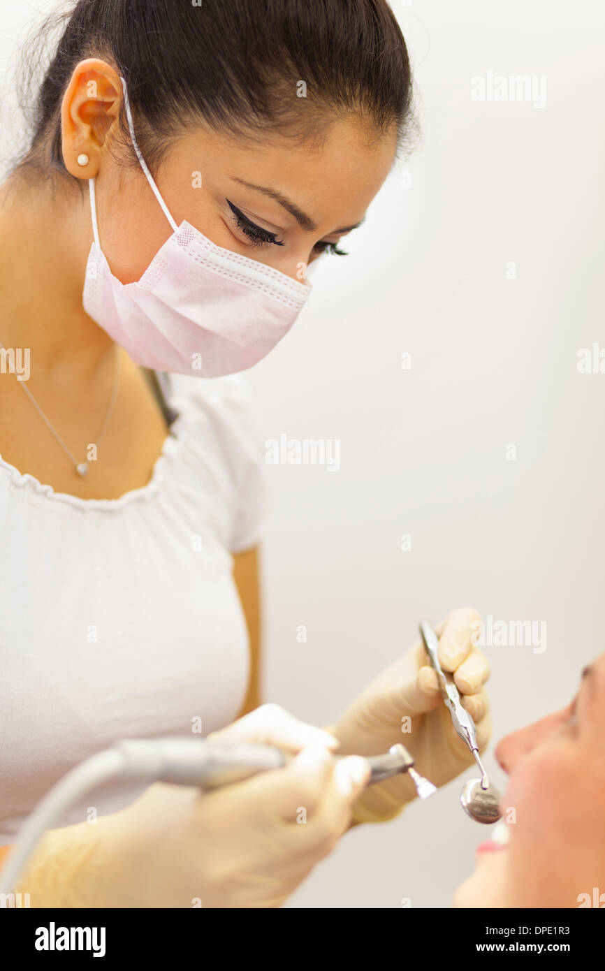 Female dentist working on patient Stock Photo