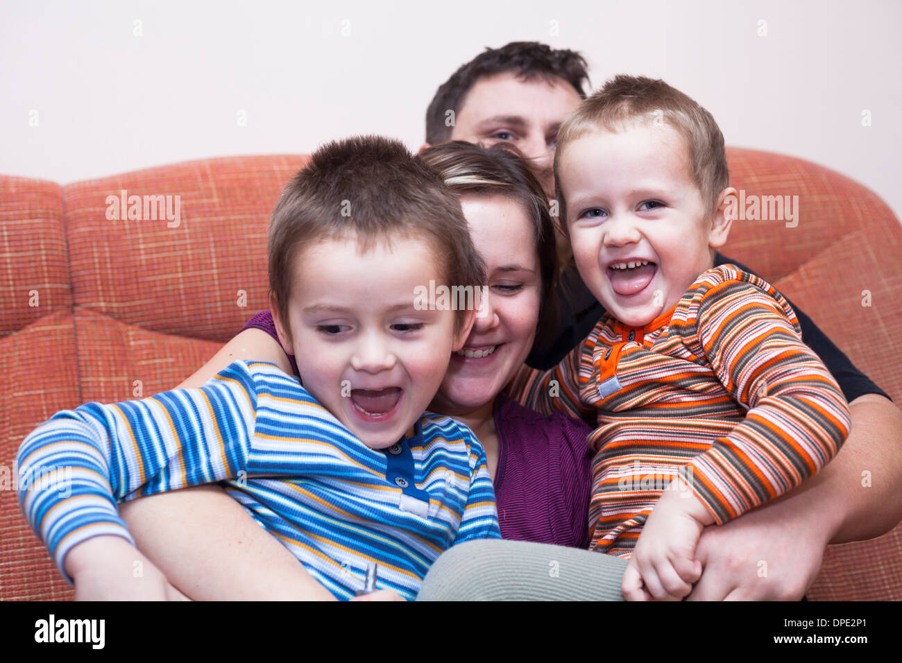 Happy parents with children having fun at home Stock Photo