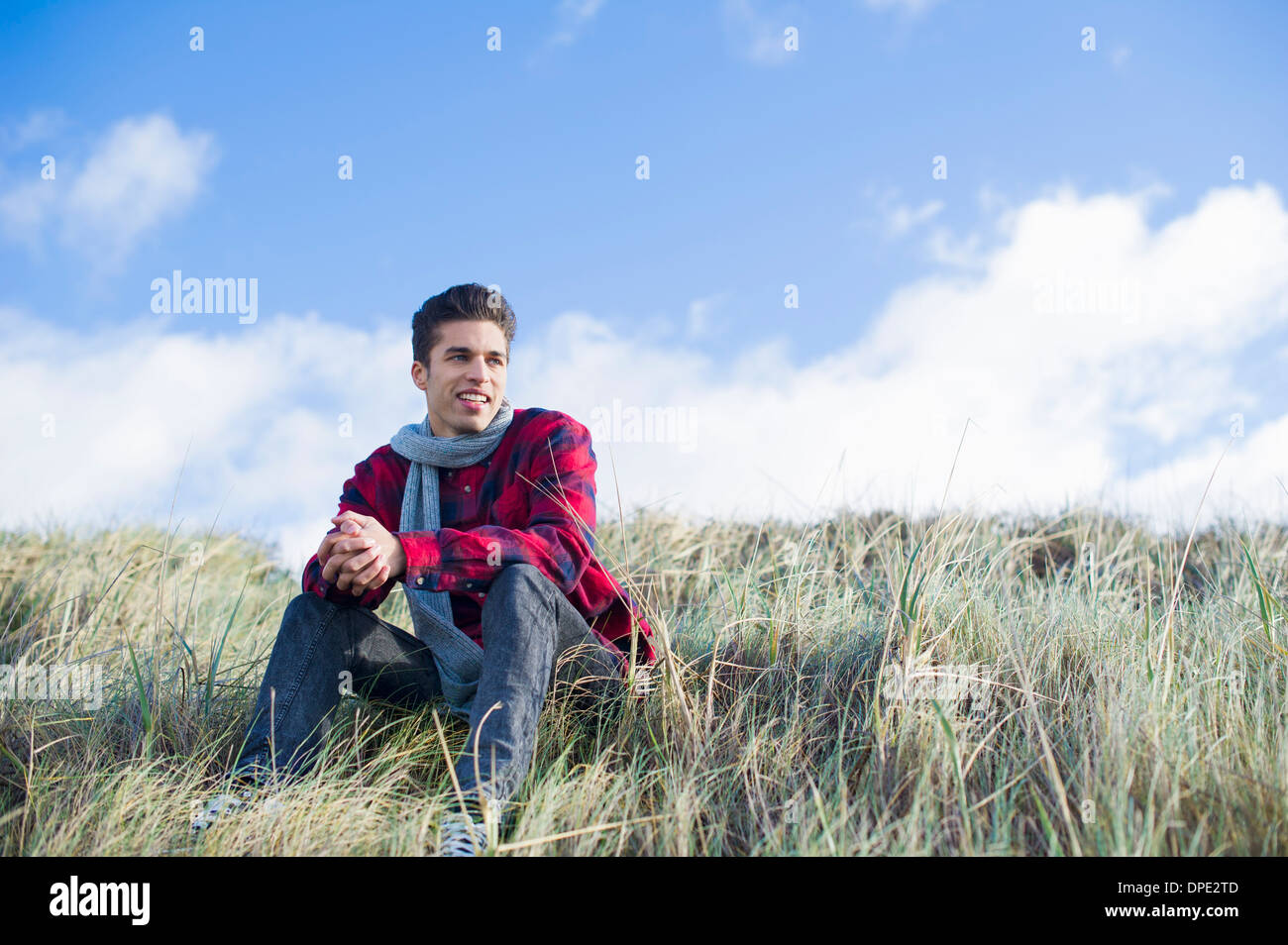 Young man sitting on grass Stock Photo