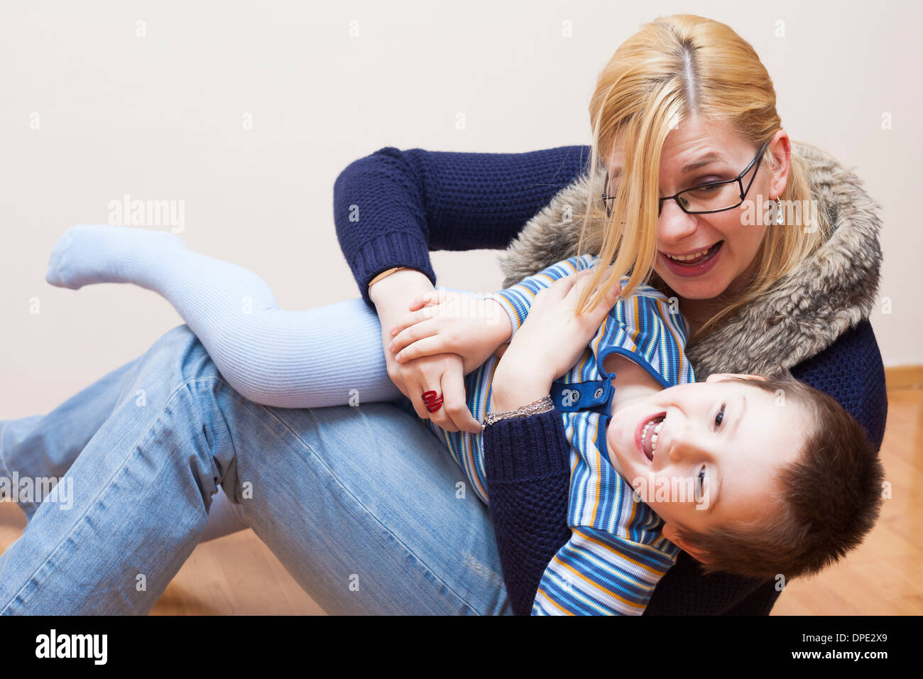 Happy child boy and woman having fun at home Stock Photo
