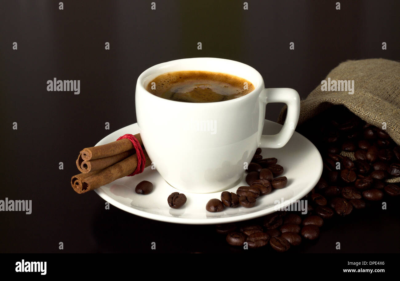 white coffee cup with beans vintage sack on table Stock Photo