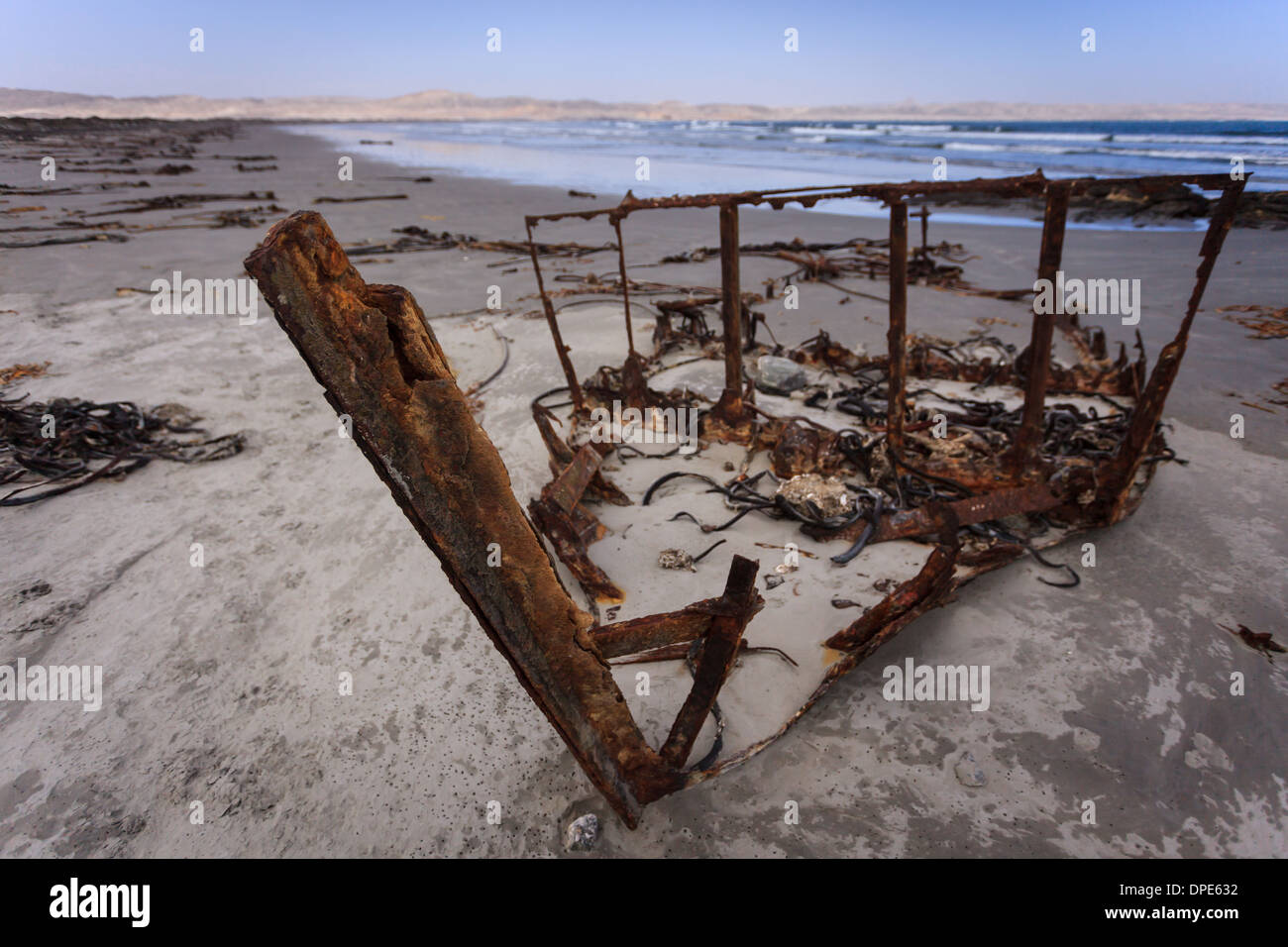 Skeletal remains of a fishing boat up close on Skeleton Coast Namibia Stock Photo
