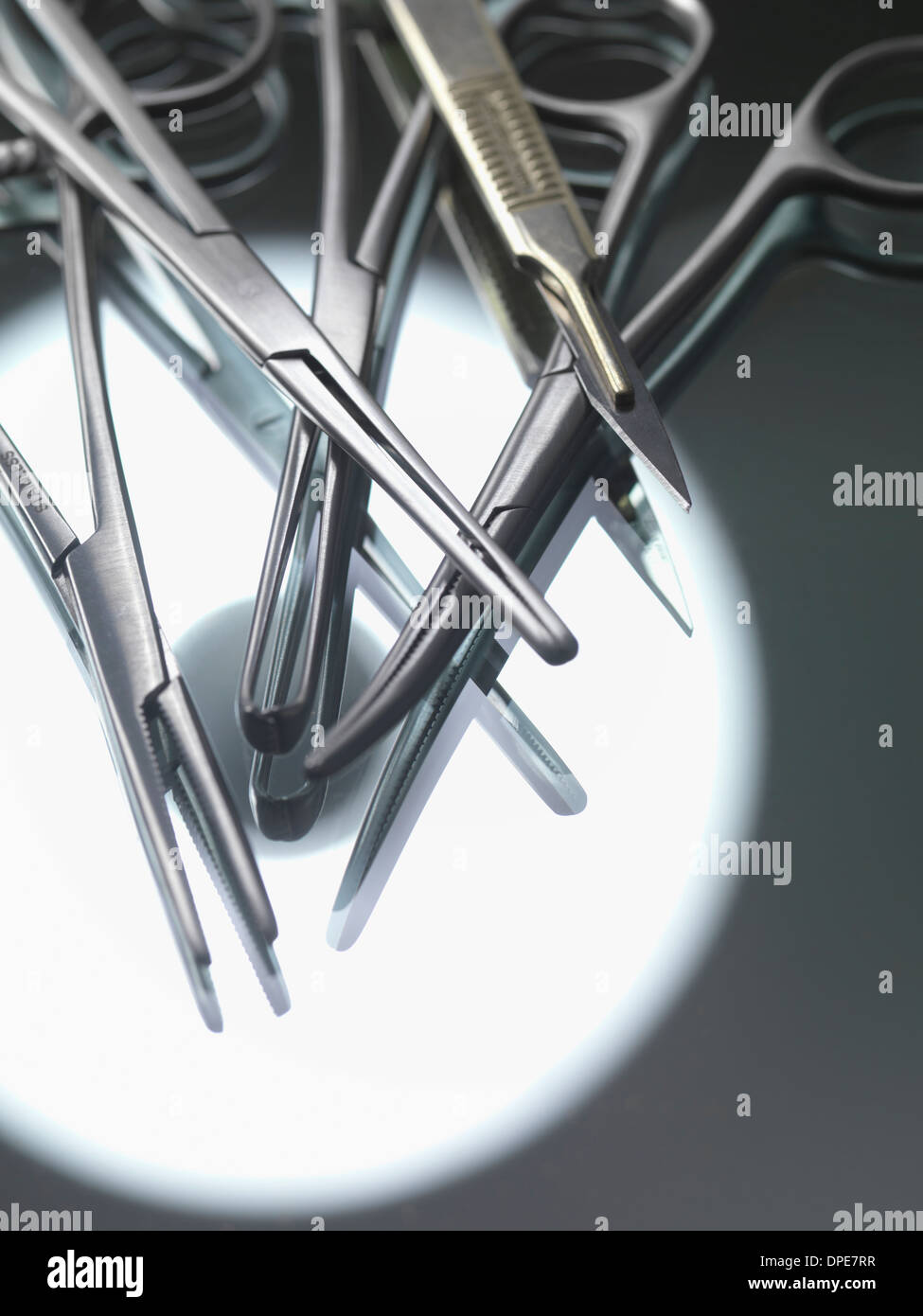 Surgical instruments on sterile tray with reflection of theatre light Stock Photo