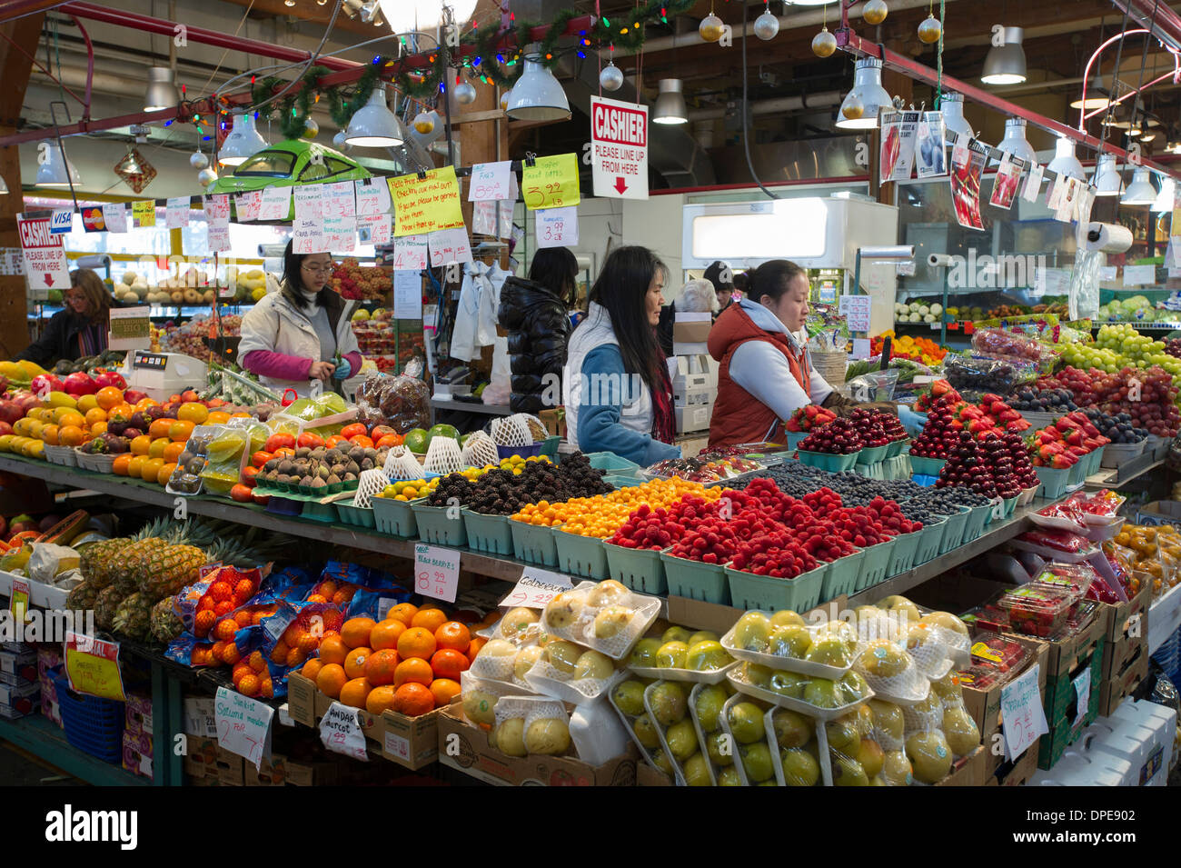 Fruit stand and vendors at Granville Island Farmers Market, Vancouver