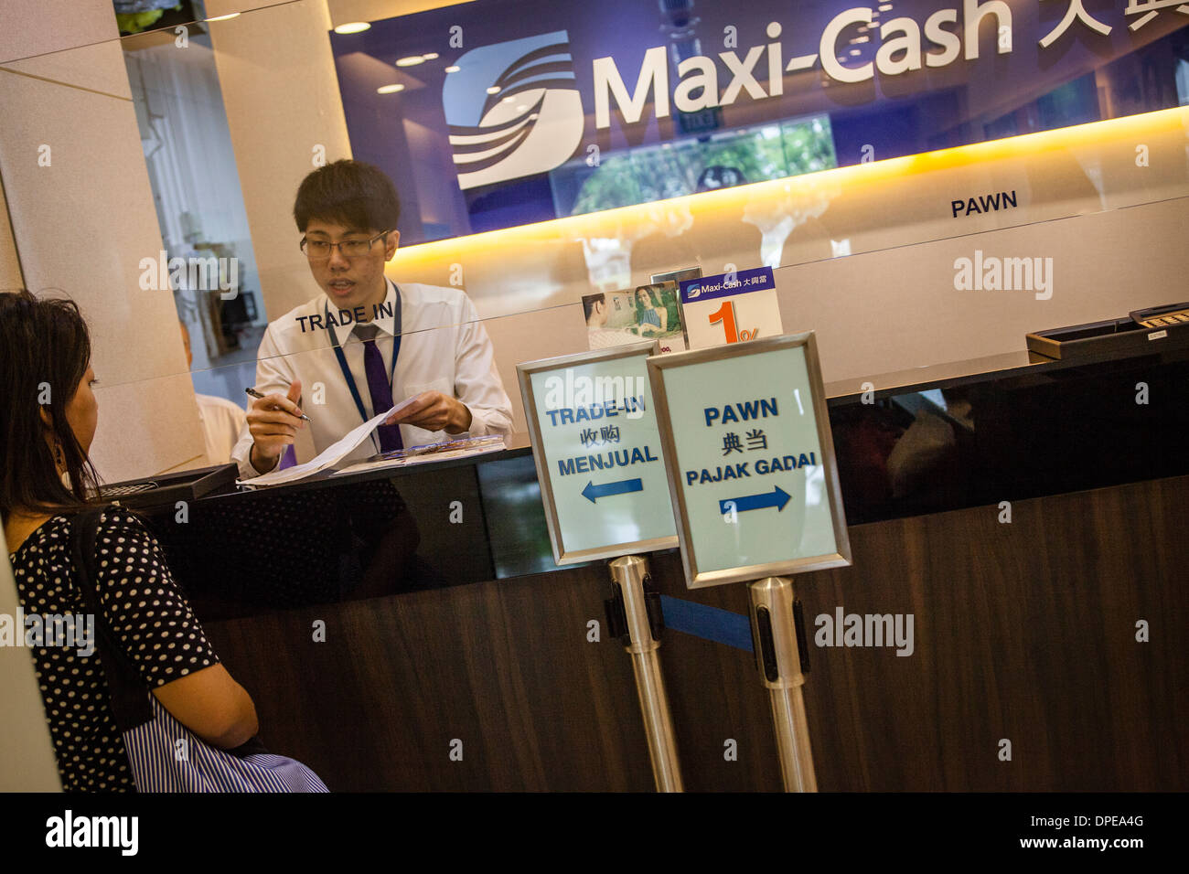 A customer redeems pawned goods at a branch of MaxiCash pawn brokerage