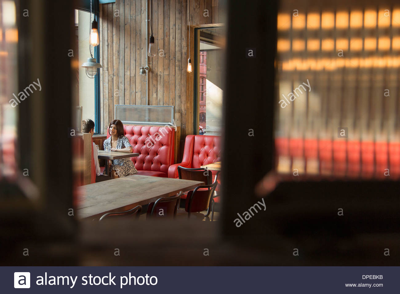 Couple Sitting In Restaurant Booth High Resolution Stock Photography