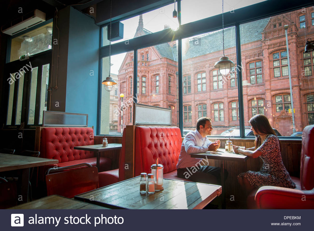 Couple Sitting In Restaurant Booth High Resolution Stock Photography