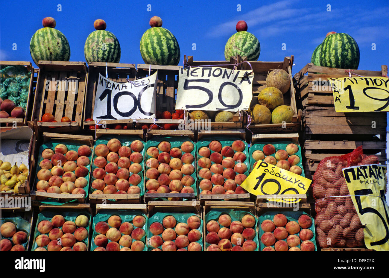 Display of Greek Fruit Peaches & Melons on Market Stall or Fruit Stall Priced in Drachma Greece Stock Photo