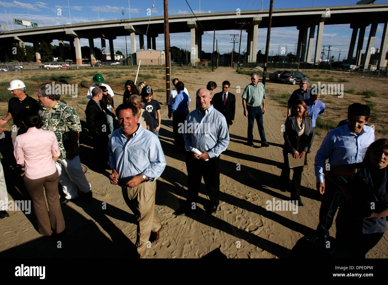 (Published 10/29/2006, B-1) October 5, 2006 San Diego, CA SAM MARASCO, lead developer of Mercado Alliance, left, walks with ROGER SHIPP, center, and others as they finish with a portrait of a group of contributors to the project. The group had plans to build a housing and commercial center on a 6.8 acre site in Barrio Logan at the intersection of CESAR E. CHAVEZ Parkway and Newton  Stock Photo