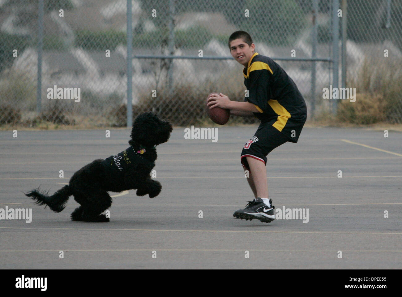 (Published 10/14/2006, A-14) October 13th, 2006, Clairemont, California, USA. Facility dog Annie gets some exercise chasing a ball with ANTONIO CORONA at New Dawn School on Friday in Clairemont, California. Annie was at the school for final testing to be certified as a facility dog.  Mandatory Credit: photo by Eduardo Contreras/San Diego Union-Tribune/Zuma Press. copyright 2006 San Stock Photo