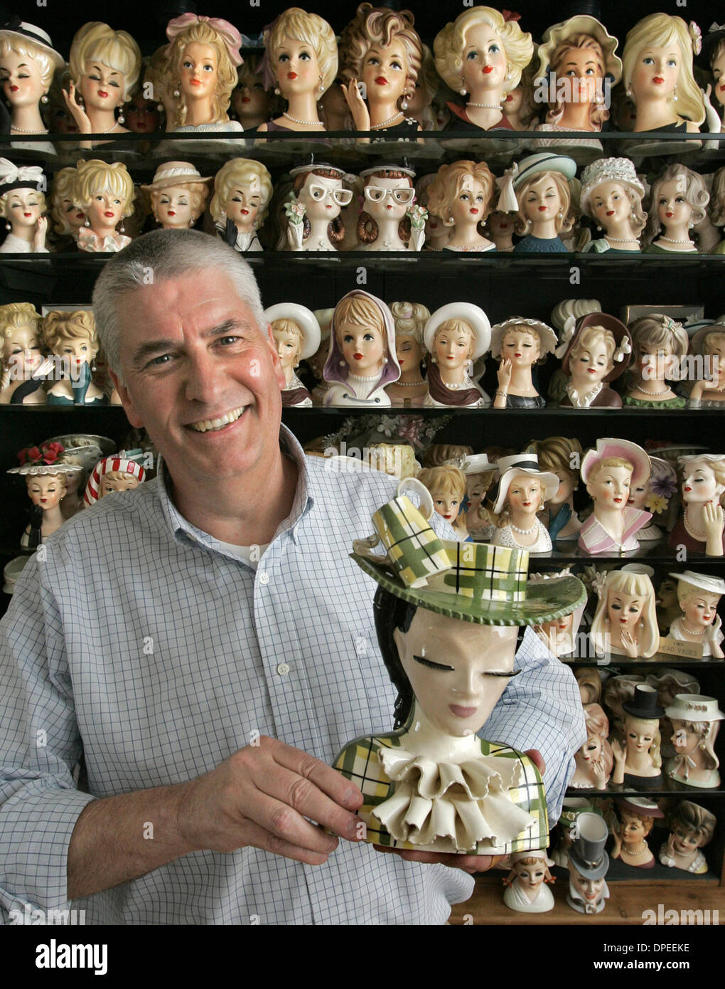 (Published 6/26/2005, E-2)  Portrit of JOHN AMICK at home with some of his extensive head vase collection. He's holding Flora Stock Photo