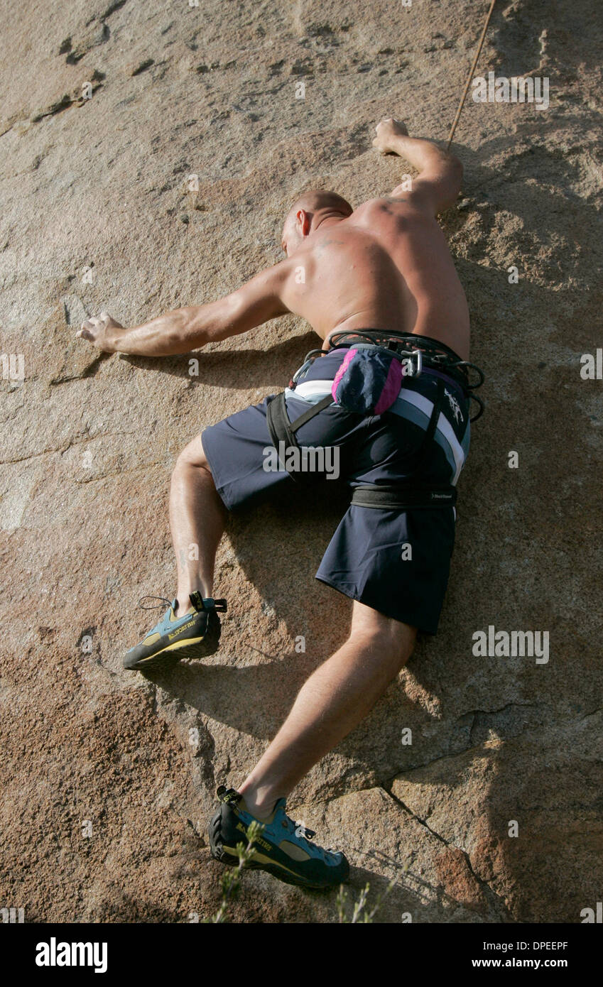 (Published 1/21/2006, E-12)  Rock Climber COLE CARTER, a former Marine, clings precariously to a boulder on Mt. Woodson, as he makes his way to top of it.  U/T photo CHARLIE NEUMAN Stock Photo