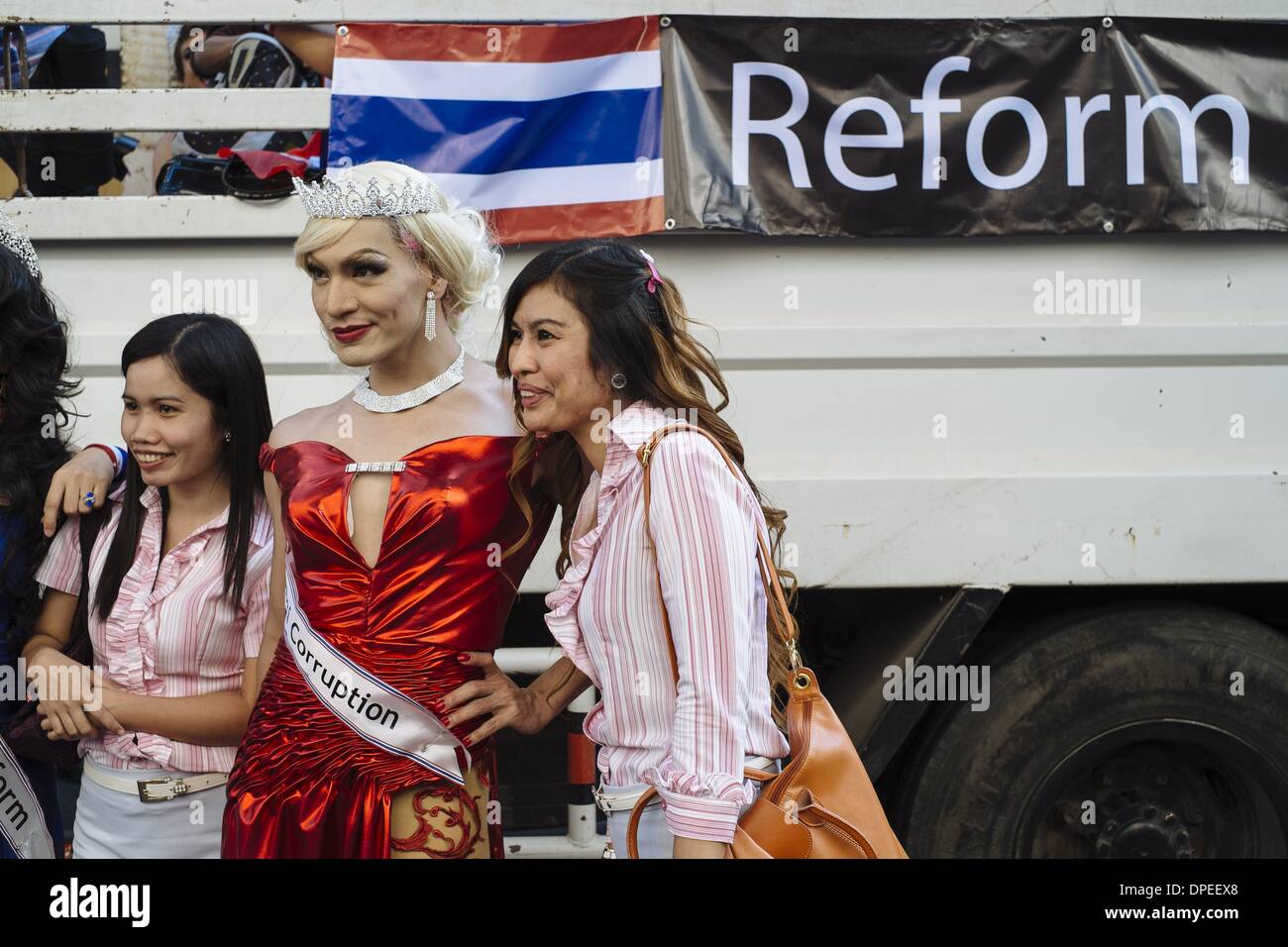 Bangkok, Thailand. 13th Jan, 2014. Anti-government protesters pose with a Thai ladyboy during the first day of the shutdown of the Thai capital. The blockade of Bangkok is the last attempt by royalists and the urban middle class to force out the elected government of Yingluck Shinawattra. Credit:  Thomas De Cian/NurPhoto/ZUMAPRESS.com/Alamy Live News Stock Photo
