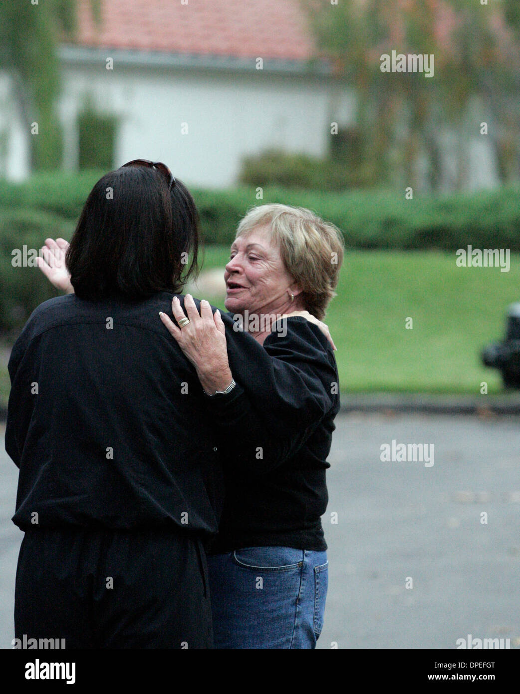 (published 10/21/2005, B-3:6, NC-1, NI-1) Widow Joane Dudek (right) gets a hug from her neighbor Sue Harris on Thursday morning in Fairbanks Ranch. In the background is Dudeks Stock Photo