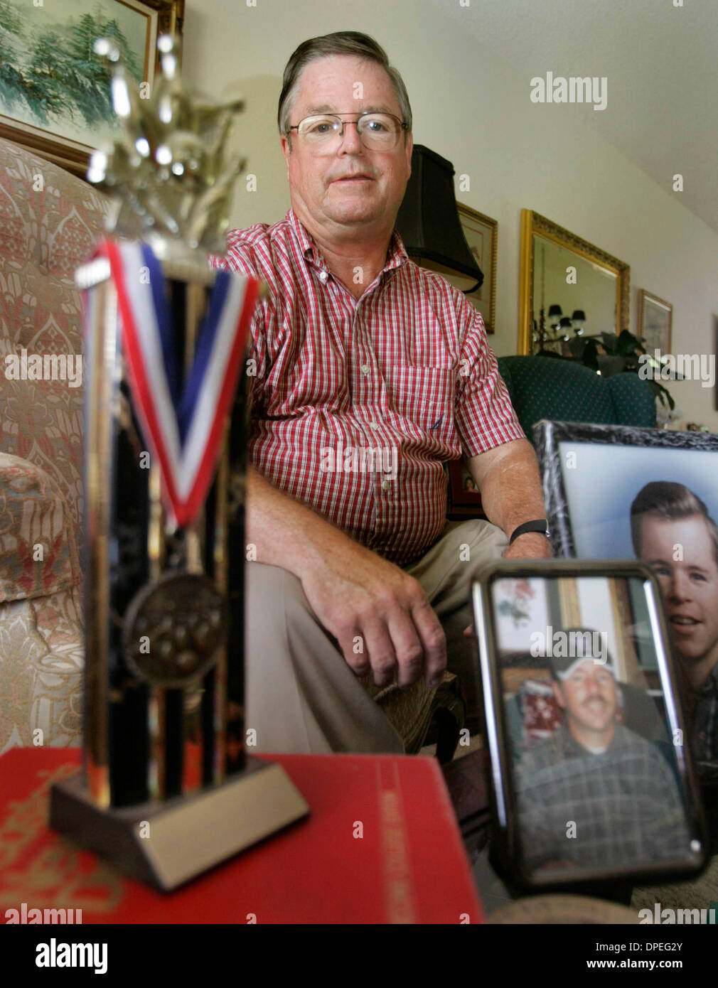 (Published 7/14/2006, NI-6) July 7, 2006, Rancho Penasquitos, California. BOB MEISSNER sat in his livingroom surrounded by photos of his son SCOTT. The trophy is from a special olympics event he won.SCOTT, was pronounced brain dead last year after a choking accident. Meissner, his daughter and his ex-wife (Scott's mother) made the decision to donate Scott's organs to help others wi Stock Photo