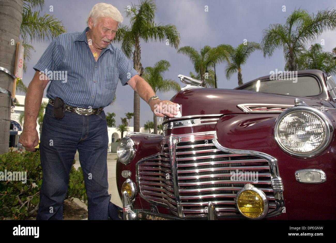 (PUBLISHED 08/07/2004, NC-4, UTS1824375) DALE HABERMANN polishes his restored 1941 Chervrolet  that's parked in front of the Oceanside Library where his model car collection is on display.  U/T photo CHARLIE NEUMAN Stock Photo