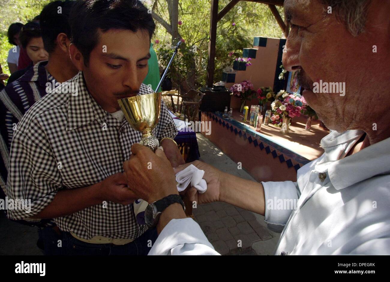 (Published 10/21/2004, E-1; UTS1839666) Pedro Cruz takes communion from Victor Martinez Garcia at the altar of the little church in the woods. Peggy Peattie photo Stock Photo