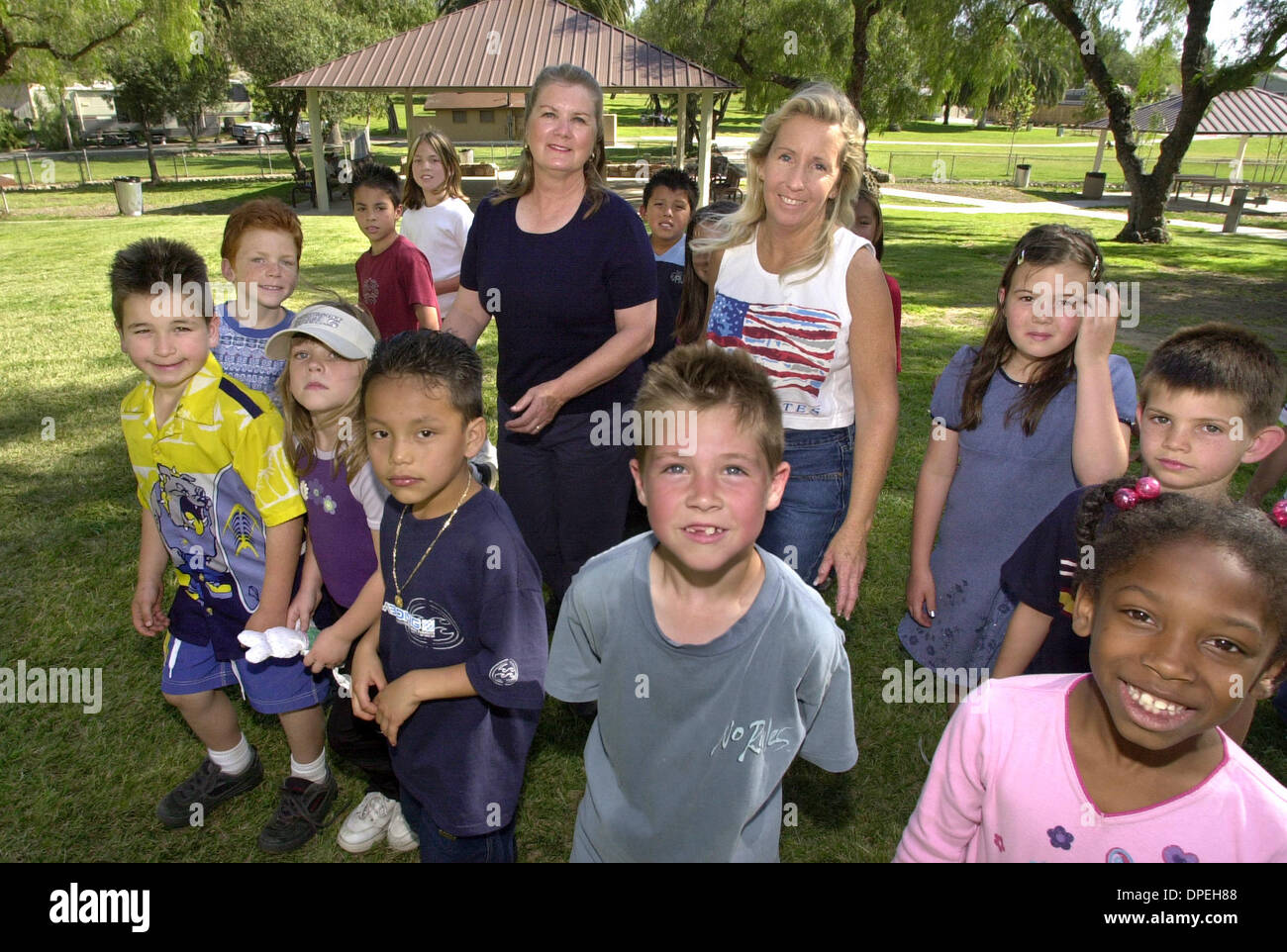 (Published 04/17/2003, NC-8; NI-6) ) BRENDA FOREMAN, at left in dark shirt, and LINDA LOWE, with white tank top, at Collier Park with kids from the nearby Boys & Girls Club. The park is the site of their upcoming 12th. Annual Children's Festival & Crime Prevention Fair.  U/T photo CHARLIE NEUMAN Stock Photo
