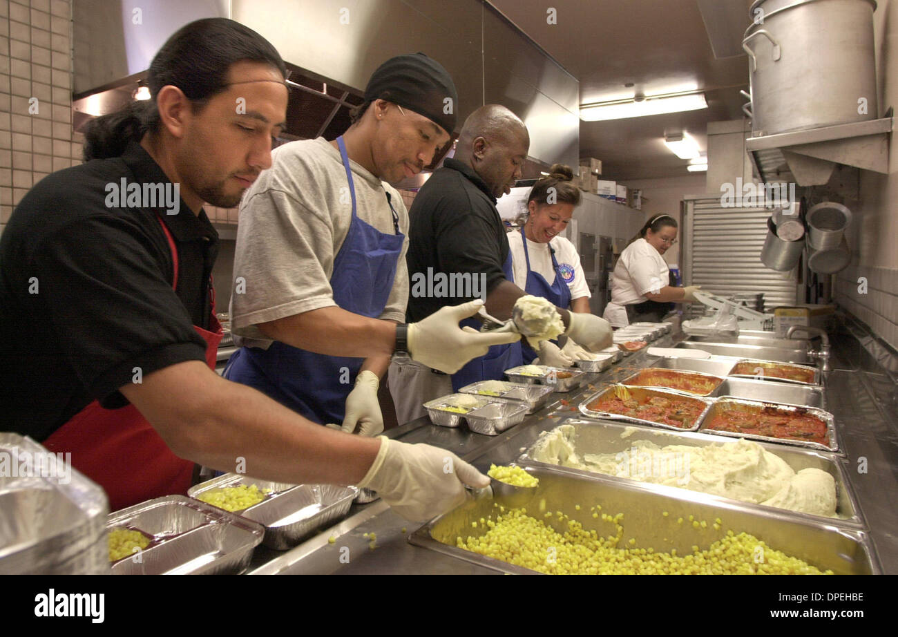 (Published 09/21/2003, N-5) ASSEMBLY LINE- McClellan Senior Center cooks prepare some of the 800 lunches they produce Monday through Friday. These lunches of stuffed peppers, mashed potatoes, and corn are some they do to be delivered. I.D.'s, LtoR: JAVIER HERNANDEZ, CARLOS TAYLOR, WALTER HARTMAN (Food Service Manager), TRICIA FITCH, and LETTIE GIBBS.  U/T photo CHARLIE NEUMAN Stock Photo