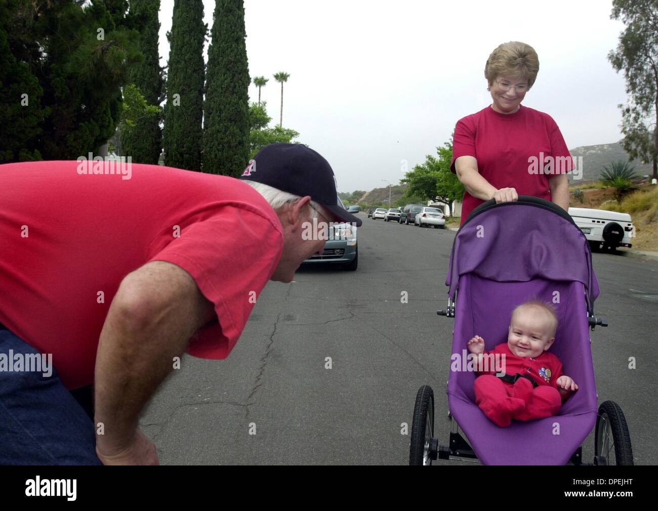 (published 07/14/2004, F-1:1,2,6,7; UTS1819381) A morning walk in their San Carlos neighborhood is interrupted by grandpa Frank fussing over six-month-old grandson Riley (cq) Jones as grandma Carolyn White  looks on. Carolyn was told to use drugs to lower her cholesterol 8 years ago. but after the dose was escalated in 1999, she started having muscle pain, which worsened to the poi Stock Photo