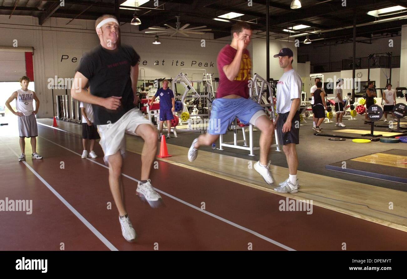 (Published 7/4/2004, N-17, UTS1817693) ROD WILSON, at left, and RYAN DIETZ run sprinting drills at the direction of trainer JUSTIN FRANDSON, standing at right, at Athlete's Edge new Vista facility.  U/T photo CHARLIE NEUMAN Stock Photo