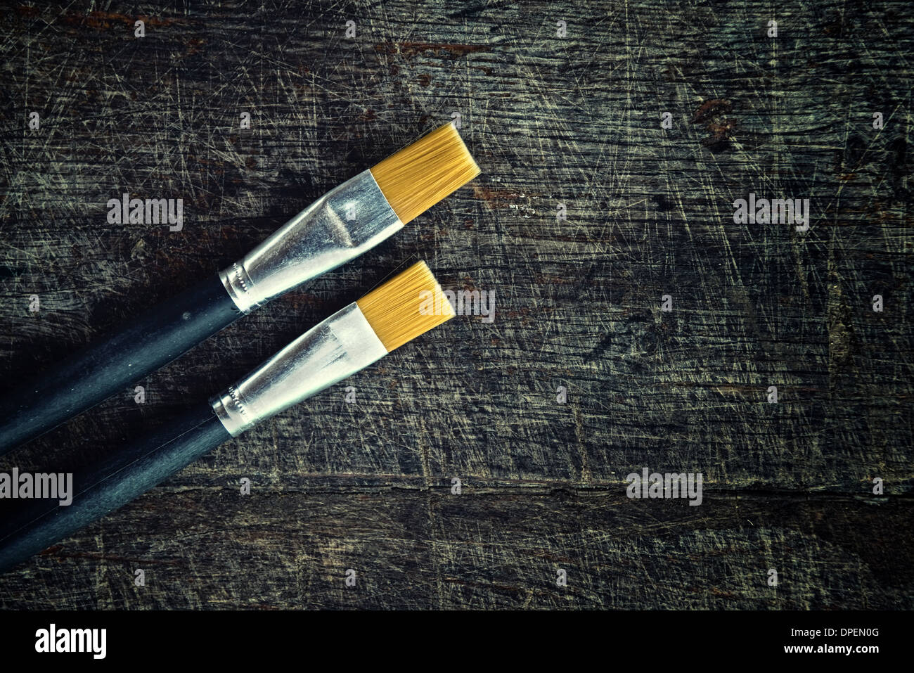 Paint brushes on old wood background Stock Photo - Alamy