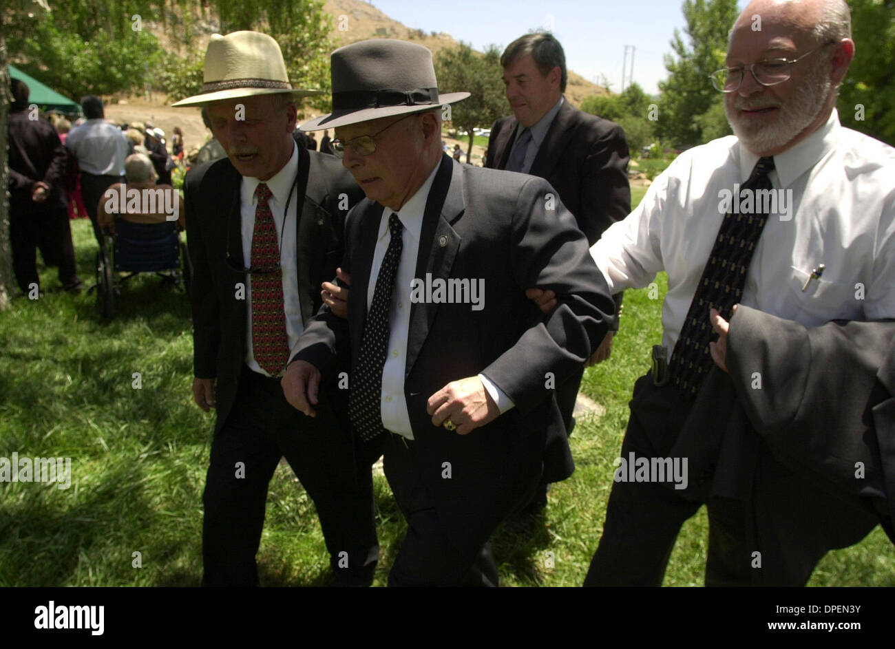 (Published 7/9/2006, J-8) Wendell Cutting, center, is helped away from the burial site of their friend Cato Cedillo, by Gary Becks, left, and Larry Cutting, right, Wendell's twin brother. In the background is Wendell's boss, Rep. Duncan Hunter. Cedillo was a much loved local personality who started Olympicos a soccer league for young kids in East County. His death affected Wendell  Stock Photo