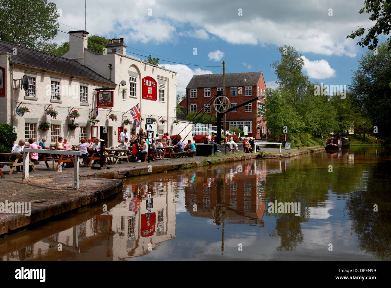 The Shroppie Fly pub and Audlem mill by the Shropshire Union Canal in the village of Audlem, Cheshire Stock Photo