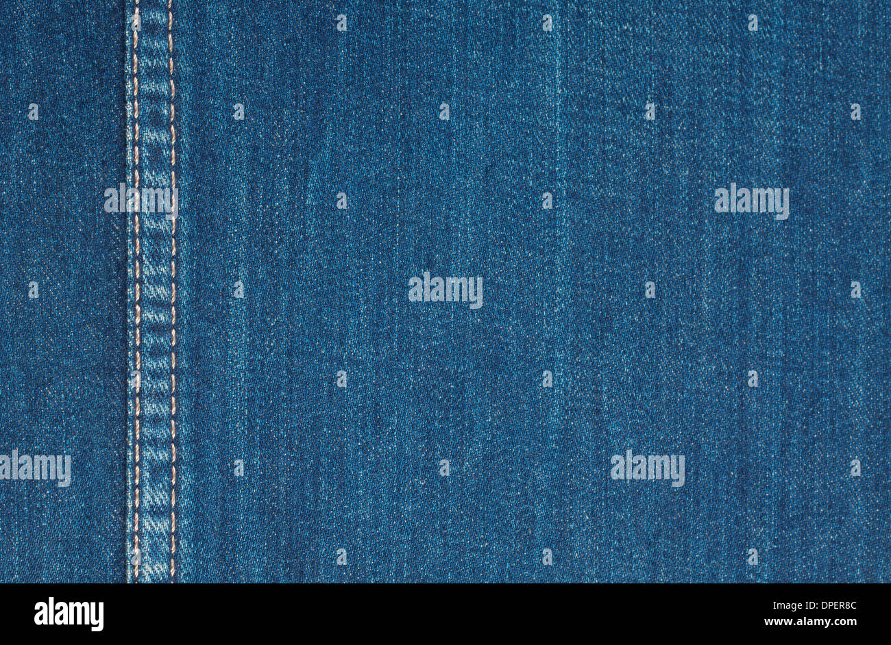 Background of rough denim fabric with vertical seam Stock Photo