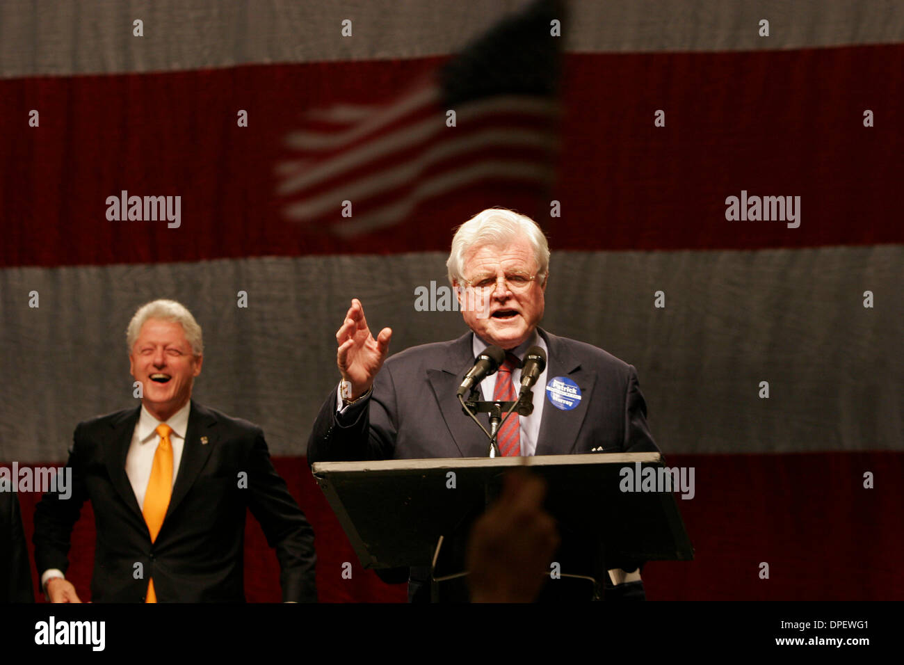 Oct 24, 2006 - Worcester , Massachusetts, USA - With former president BILL CLINTON in the background, and a supporter waving an American flag in the foreground, Massachusetts Senior Senator TED KENNEDY addresses a crowd at the Worcester DCU Center in support of the Deval Patrick campaign. (Credit Image: © Nathan Fried-Lipski/ZUMA Press) Stock Photo