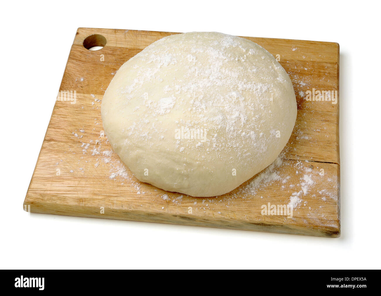 Raw wheat dough on cutting board on a white background Stock Photo