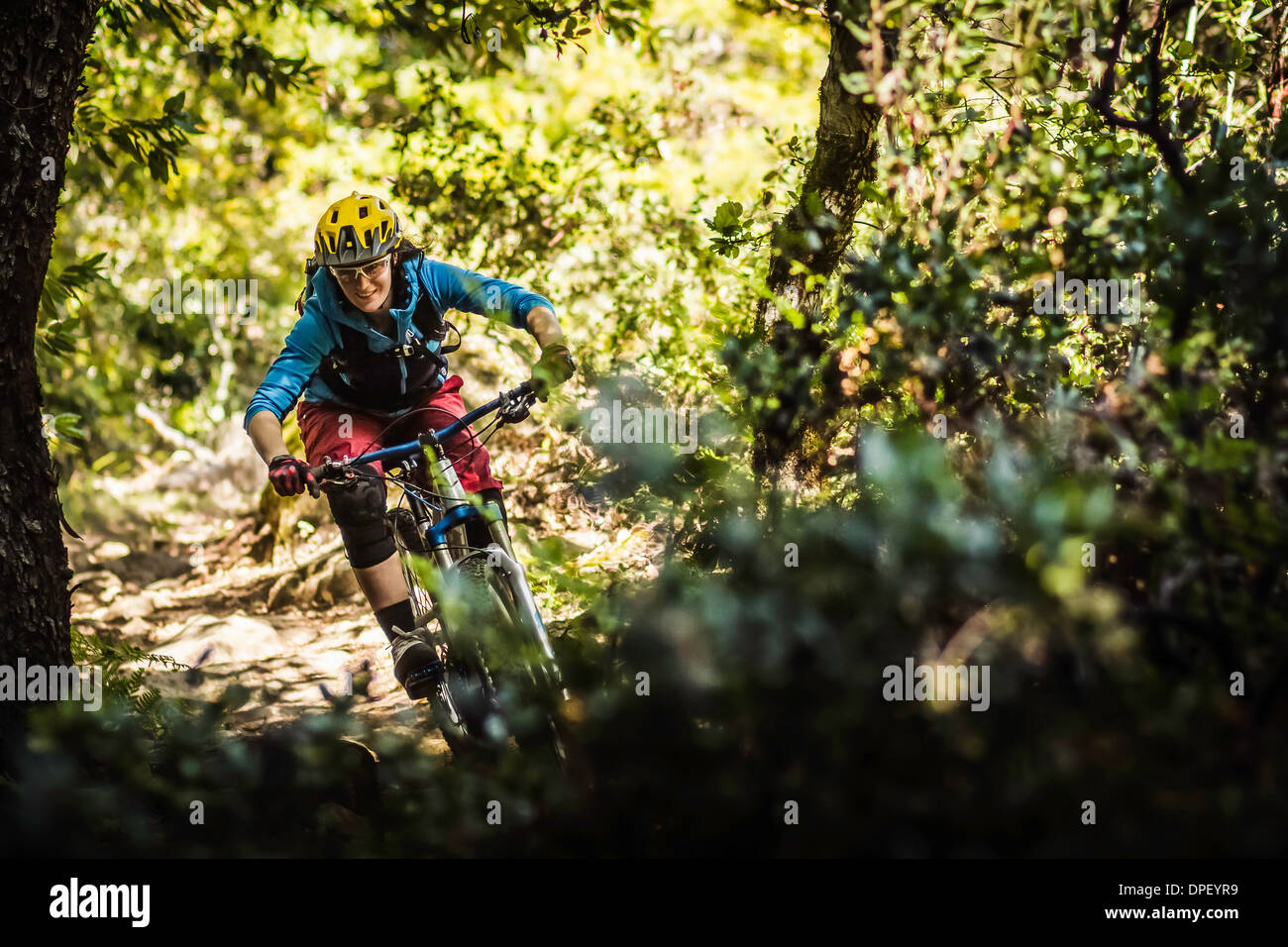 Young woman mountain biking, Soquel Demonstration State Forest, Santa