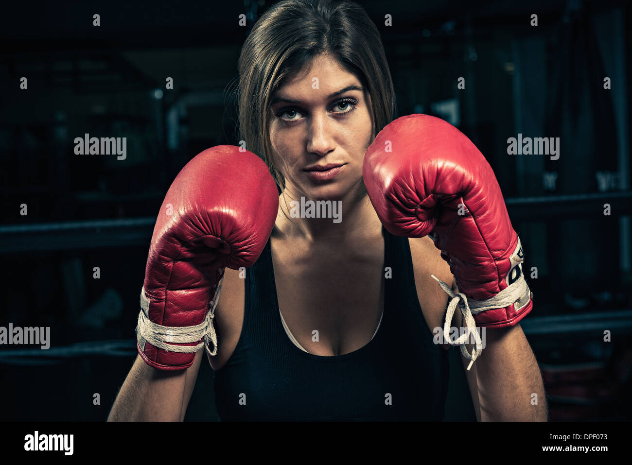 Female boxer wearing boxing gloves Stock Photo