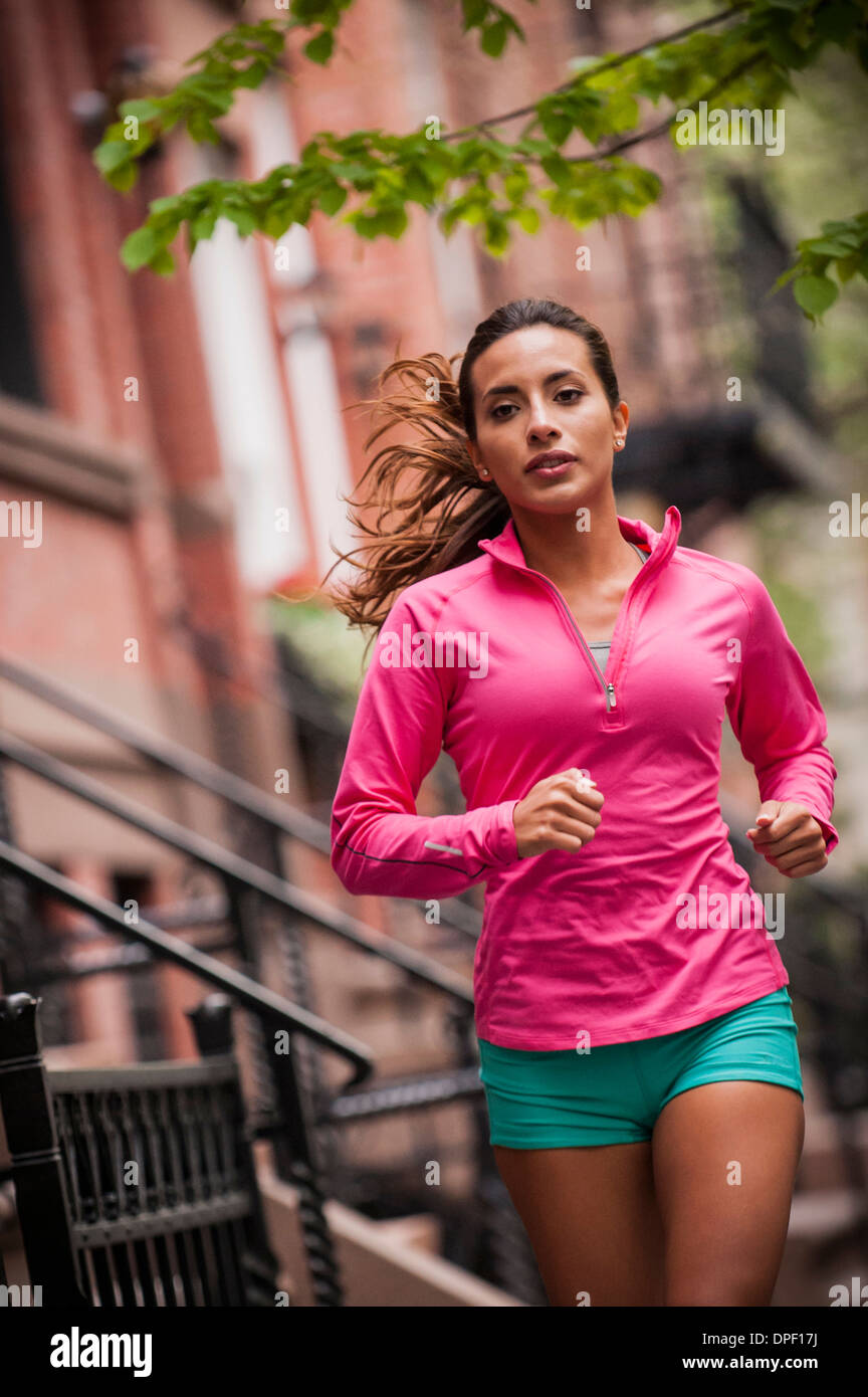 Woman jogging on sidewalk Stock Photo Alamy