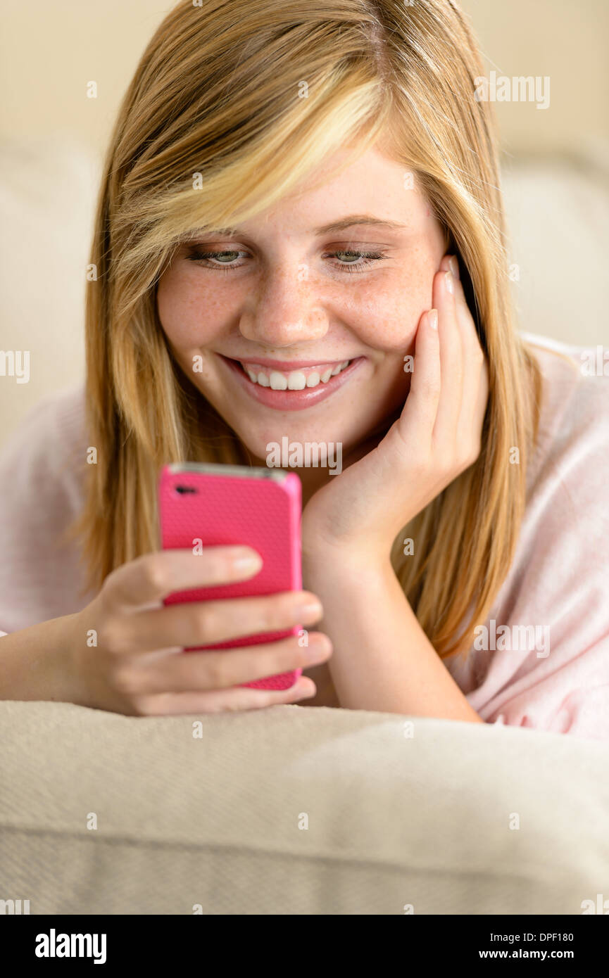 Happy teenage girl in love receive SMS on her cellphone Stock Photo