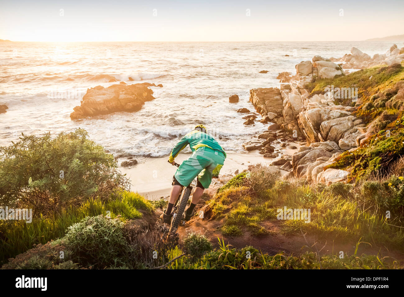 Mountain biker moving down coastal path, Monterey Bay area, California, USA Stock Photo