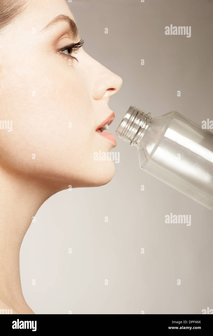 Woman drinking from bottle Stock Photo Alamy
