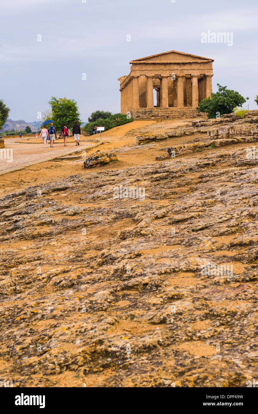 Tourists at the Temple of Concordia, Valley of the Temples (Valle dei Templi), Agrigento, UNESCO Site, Sicily, Italy Stock Photo