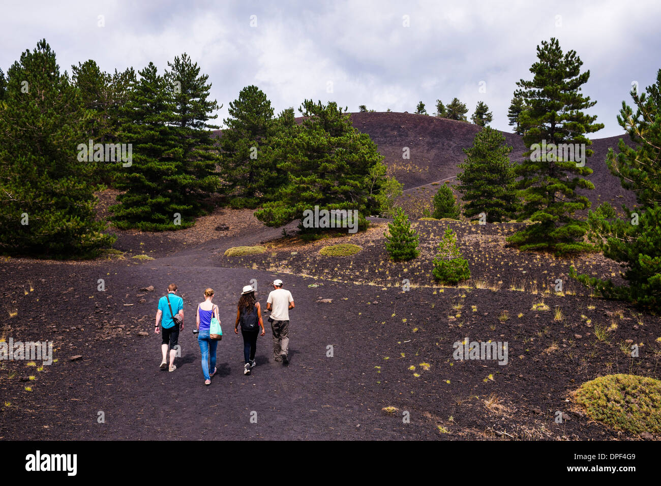 Tourists exploring an old lava flow from an eruption of Mount Etna Volcano, UNESCO World Heritage Site, Sicily, Italy, Europe Stock Photo