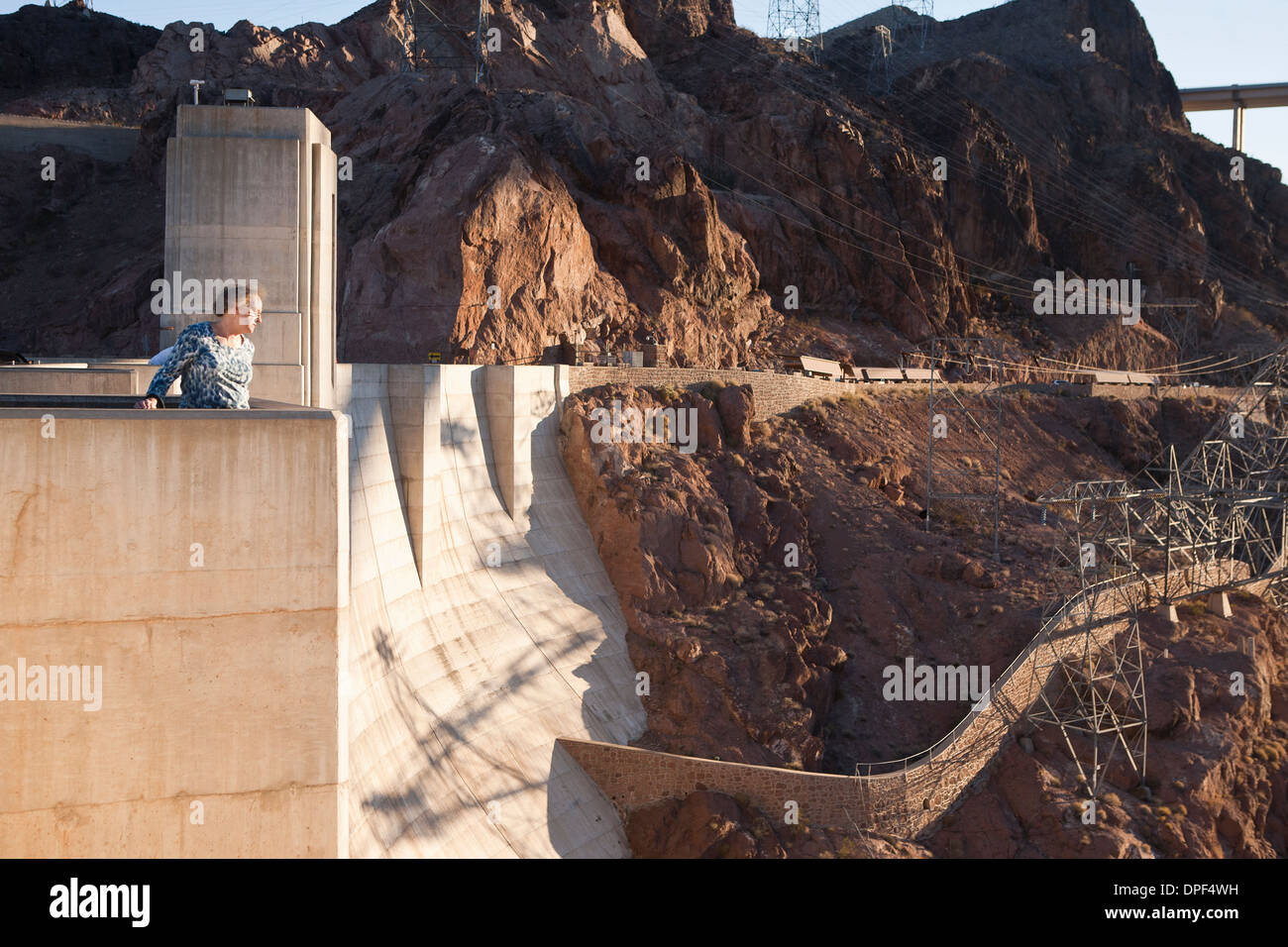Senior woman looking out from Hoover Dam, Nevada, USA Stock Photo