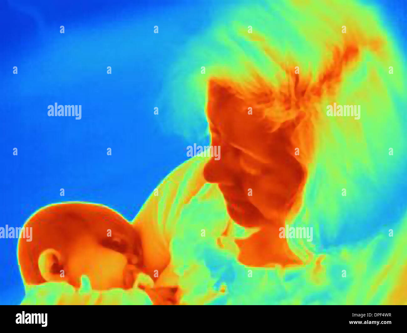 Thermal image of mother cradling six month baby boy Stock Photo