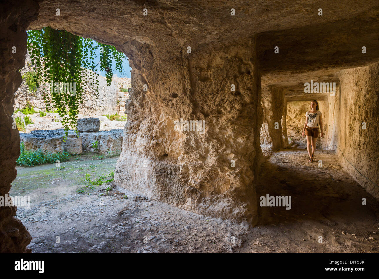 Tourist exploring the tunnels at the Greek ruins, Eurialo Casle