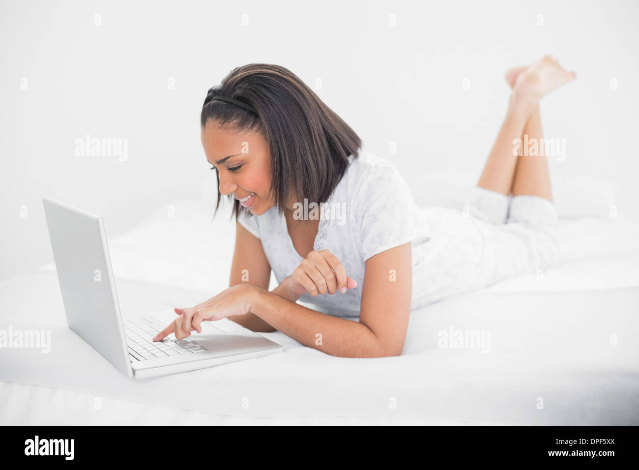 Content young dark haired model using a laptop Stock Photo