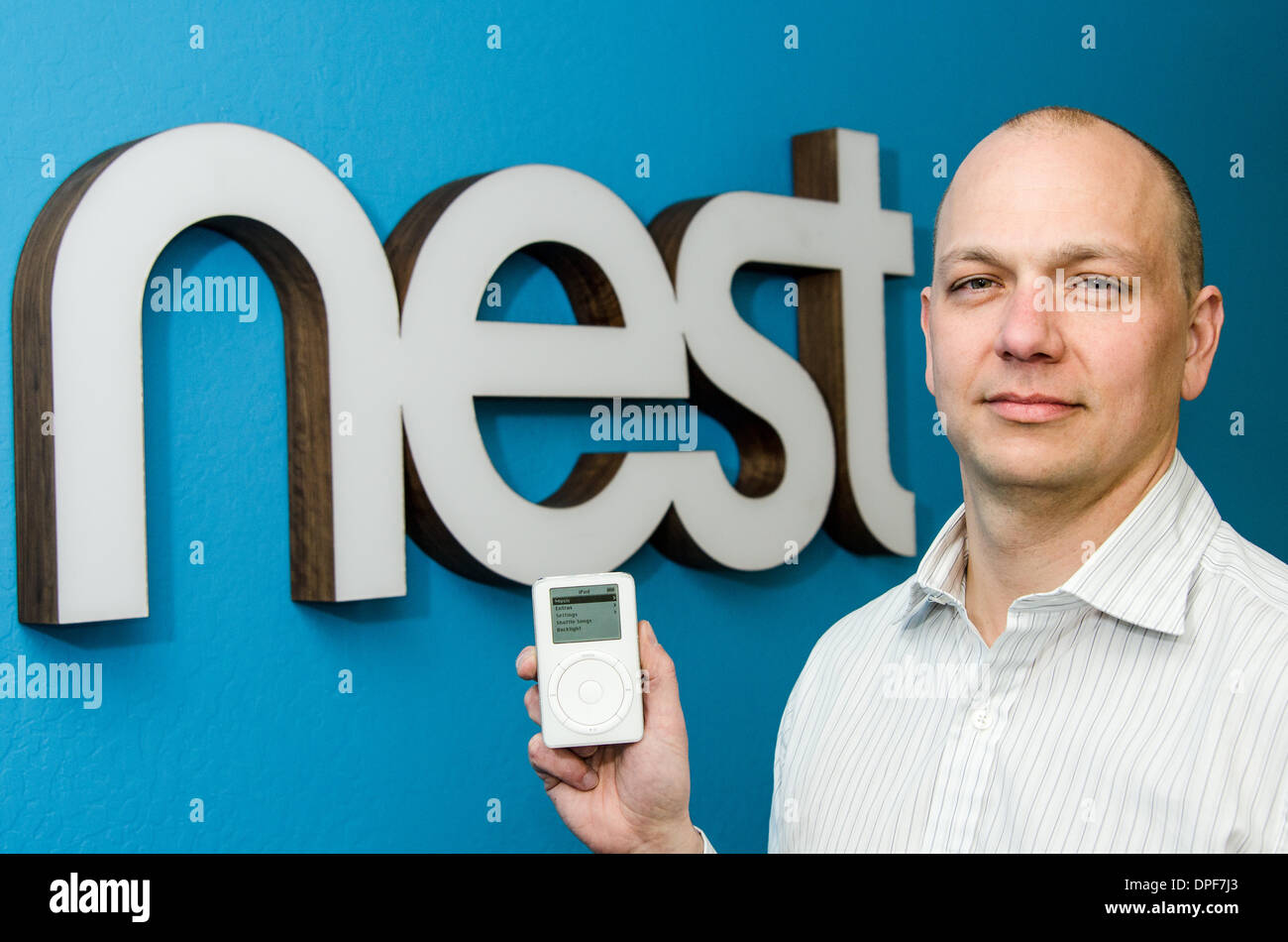 At Apple, Tony Fadell helped develop both iPod and iPhone. He co-found smart appliance maker Nest, which was acquired by Google in January 2014. In an unusual photo, Fadell is seen here in 2012 at Nest HQ in Palo Alto, CA, showing the original iPod. Stock Photo