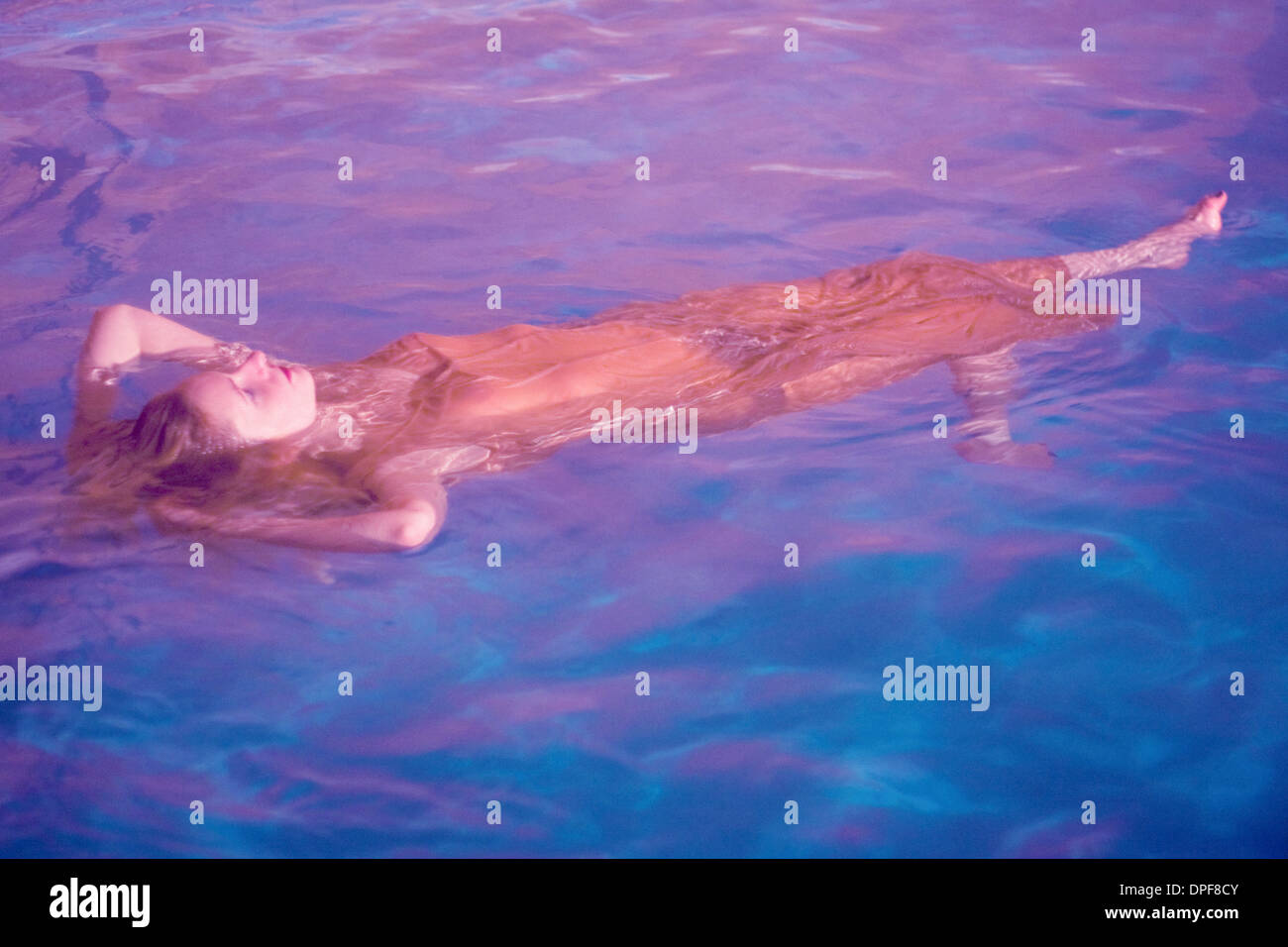 Young woman swimming underwater in pool in underwear Stock Photo - Alamy