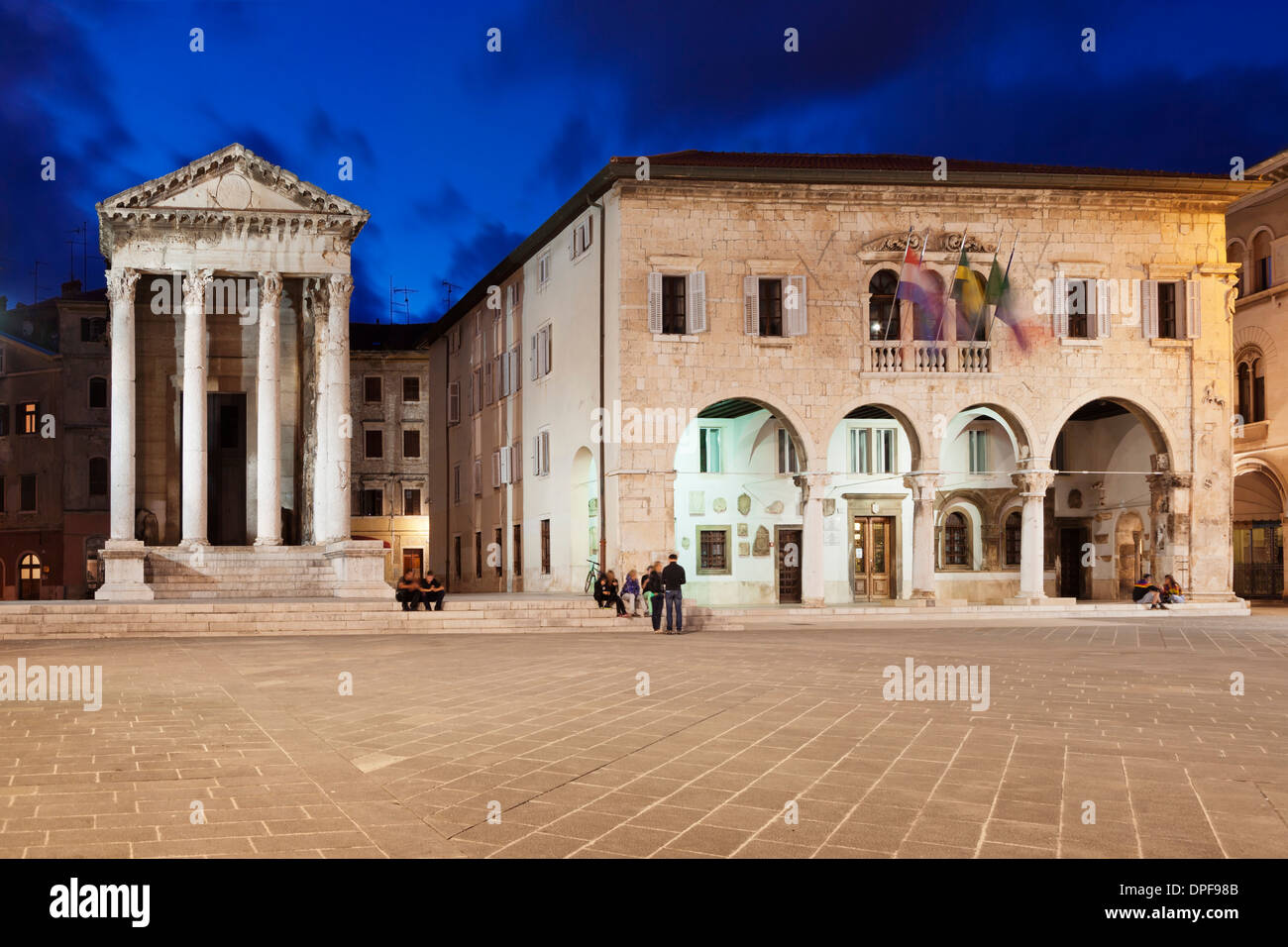 Illuminated Temple of Augustus and town hall on the marketplace in the old town at night, Pula, Istria, Croatia, Europe Stock Photo