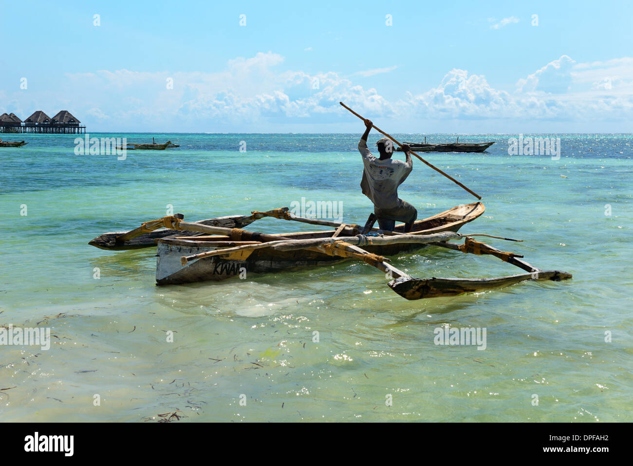 Fisherman and traditional outrigger boat, Bwejuu Beach, Zanzibar, Tanzania, Indian Ocean, East Africa, Africa Stock Photo