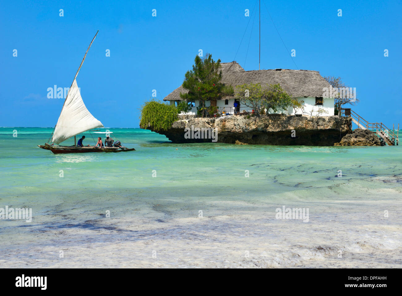 Tourist on a traditional Dhow boat, The Rock Restaurant, Bwejuu Beach, Zanzibar, Tanzania, Indian Ocean, East Africa, Africa Stock Photo